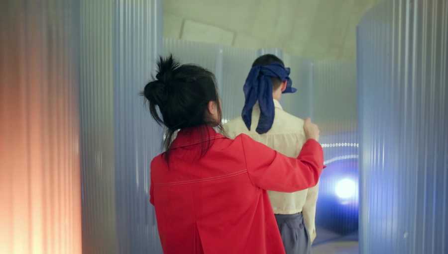 A video still showing the host gently leading the blindfolded participant into the pod. Taken from a film created by Mind The Film of Movement Alphabet by Jan-Ming Lee and Tim Murray-Browne