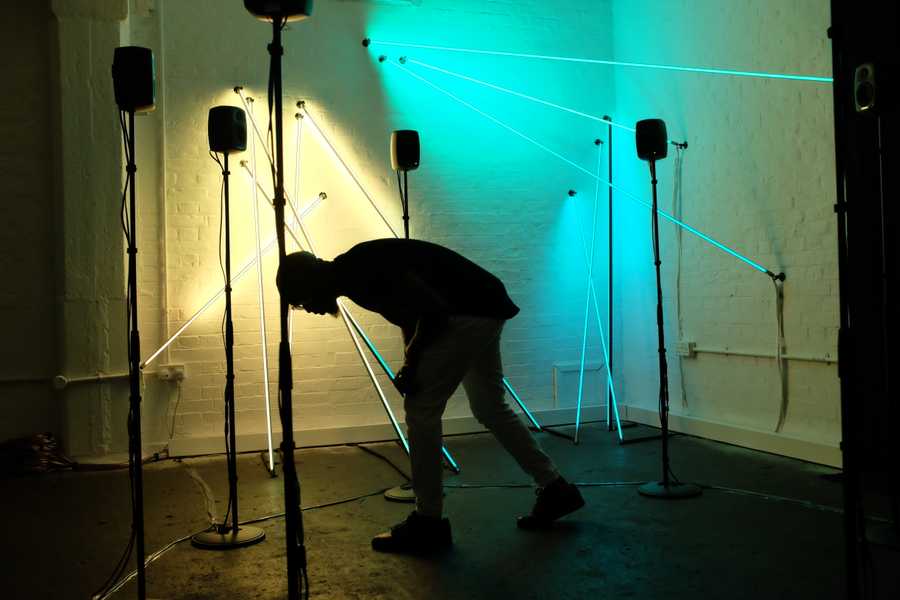 A photo of a participant interacting with the interactive light and 3D sound sculpture Post-Truth and Beauty by Tim Murray-Browne and Aphra Shemza, at Old Truman Brewery, London.