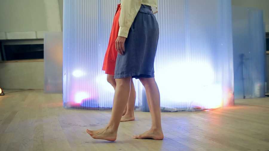 A video still showing the participant and host's bare feet walking on the ground past the pod. Taken from a film created by Mind The Film of Movement Alphabet by Jan-Ming Lee and Tim Murray-Browne